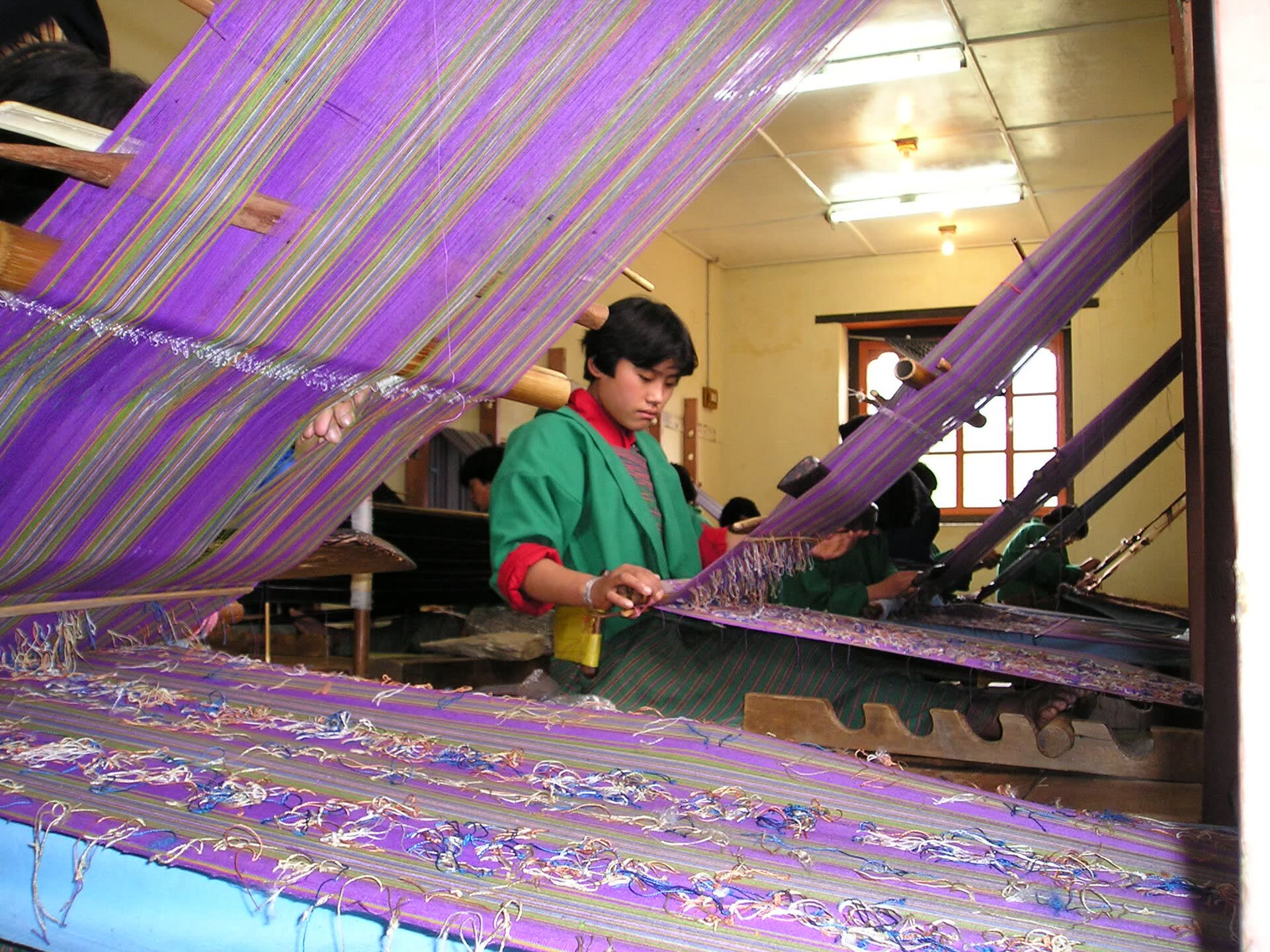 A Bhutanese weaver at her loom